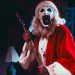 David Howard Thornton as Art the Clown holding an axe and laughing in Terrifier 3.